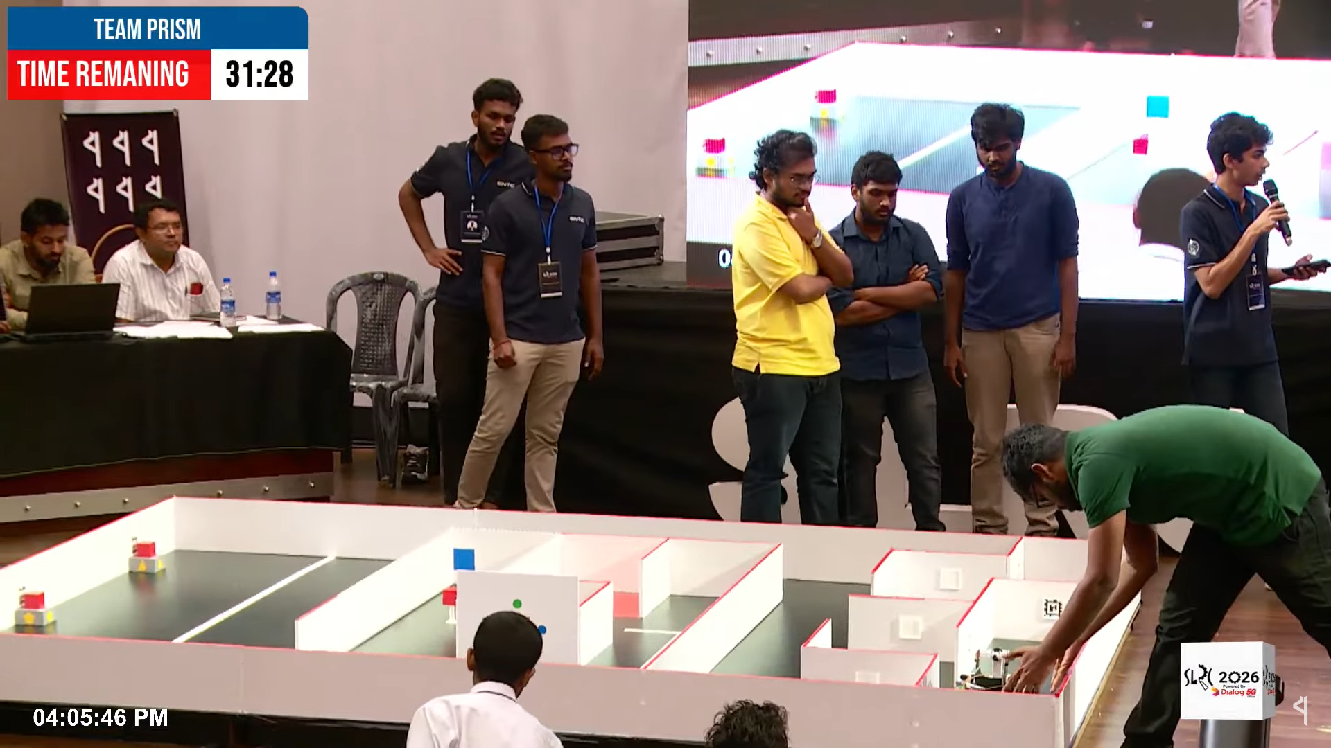 Reviewing the robot's run beside the maze during competition